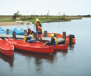 The jetty at the lake and canadian canoes